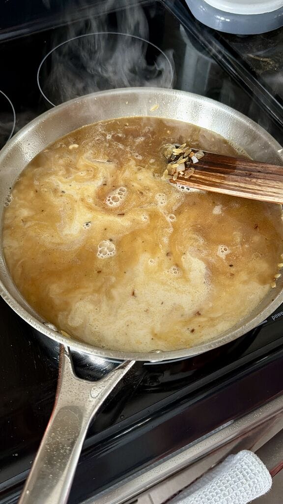 Adding the liquid to the frying pan.