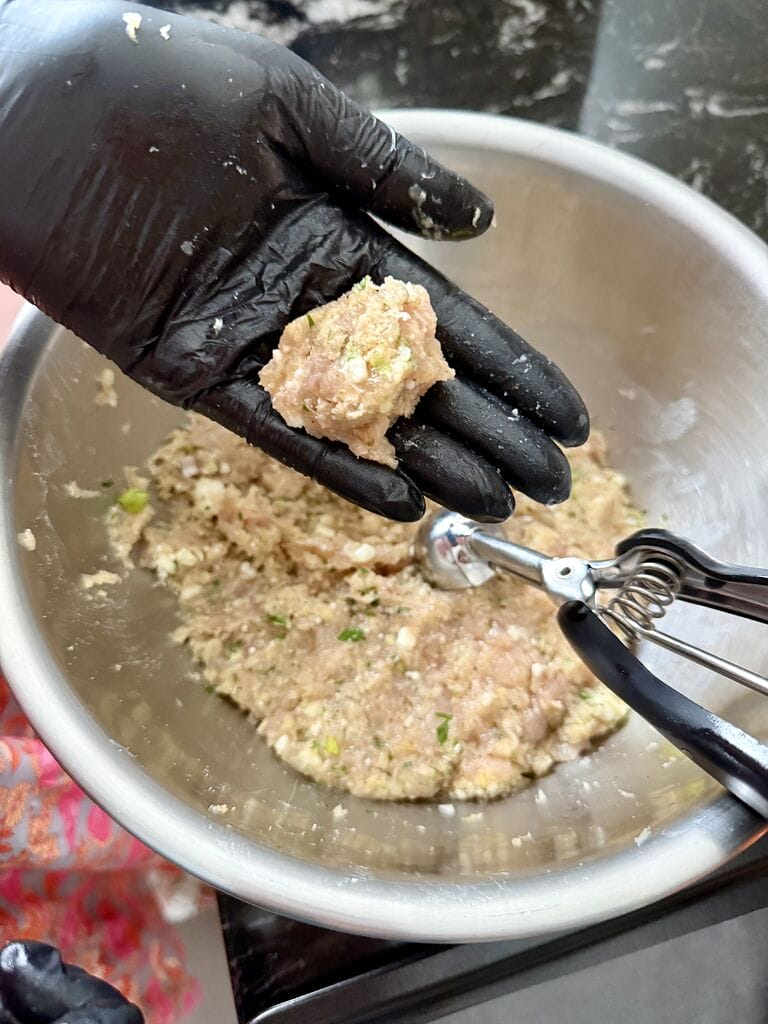 Shaping the meatballs.