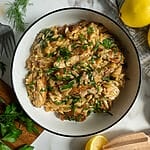 Creamy Lemon Chicken Orzo Recipe with Swiss Chard and Feta in a white bowl.