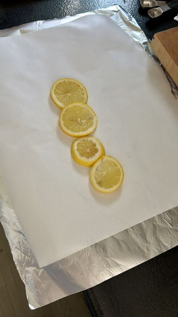 Layering the bottom with lemon slices.